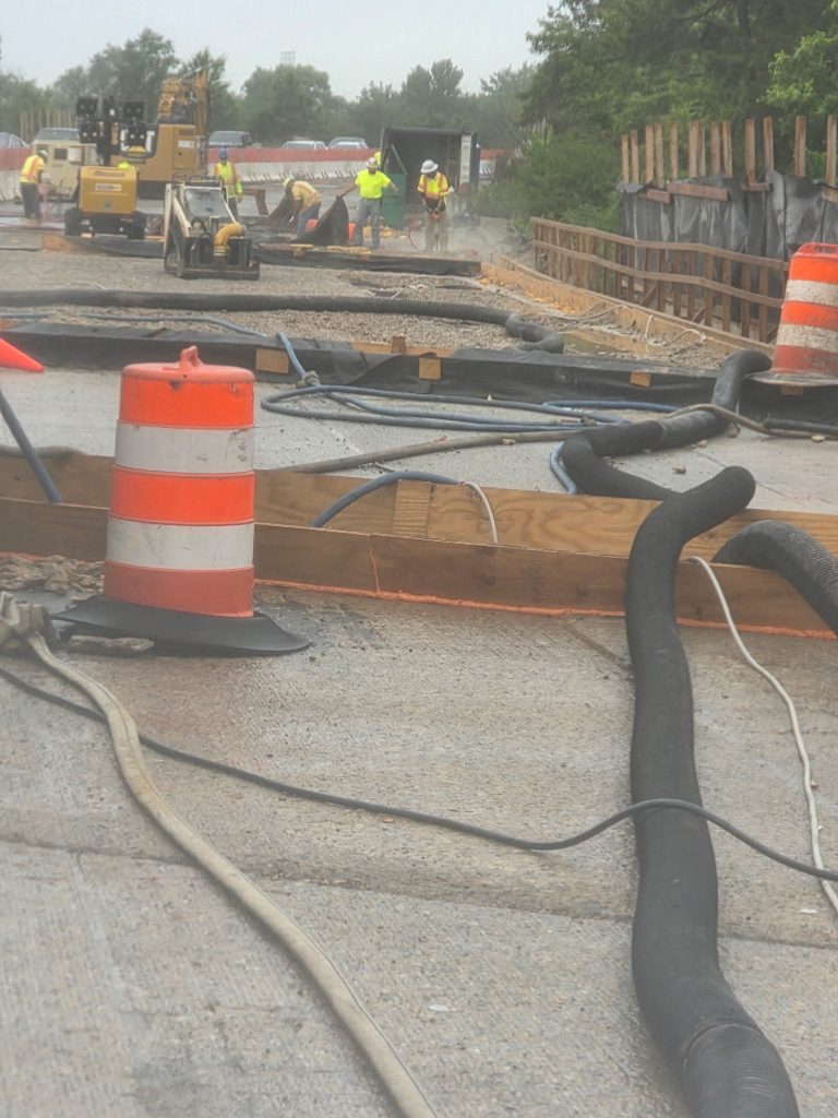 The bridge deck surface with the vac truck hose.