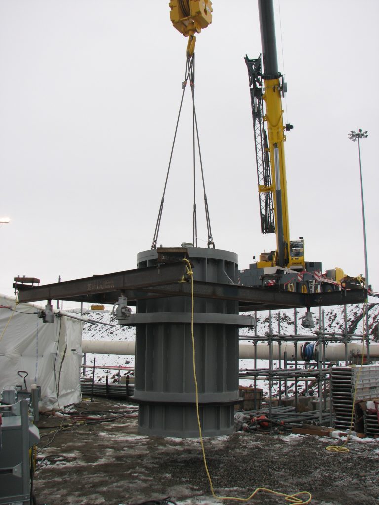 a piece of equipment suspended by a crane at a nuclear site