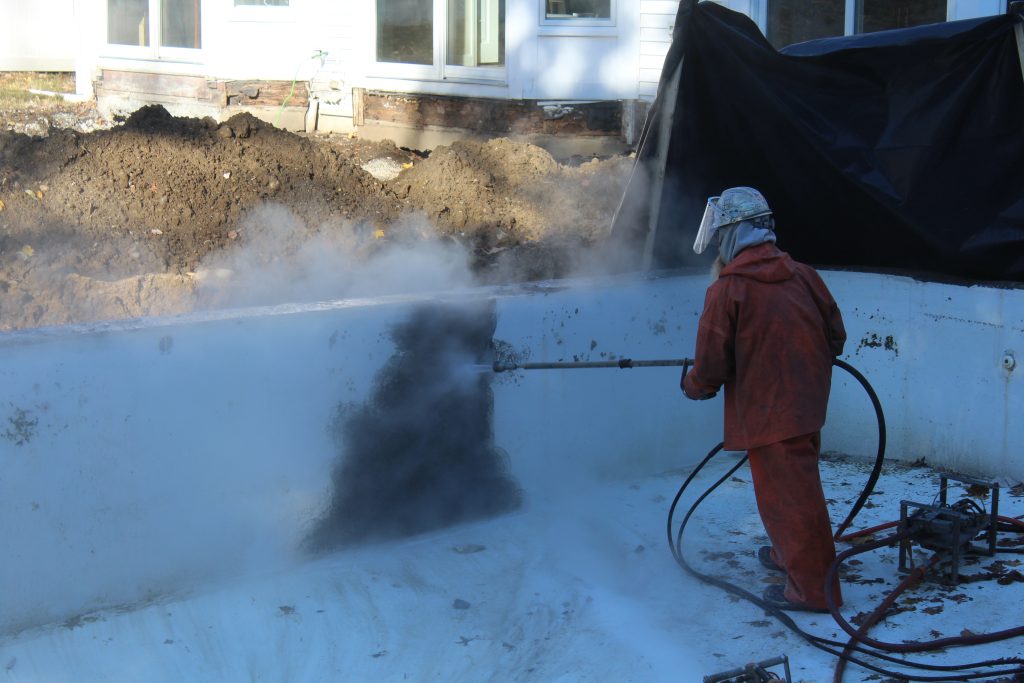 A HP hand lance removing the coating of a pool.
