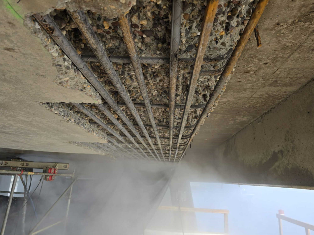 Another view of exposed overhead rebar on the underside of the bridge deck.