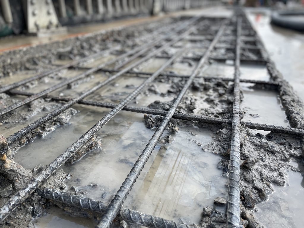 Exposed rebar after hydrodemolition for bridge deck repair.